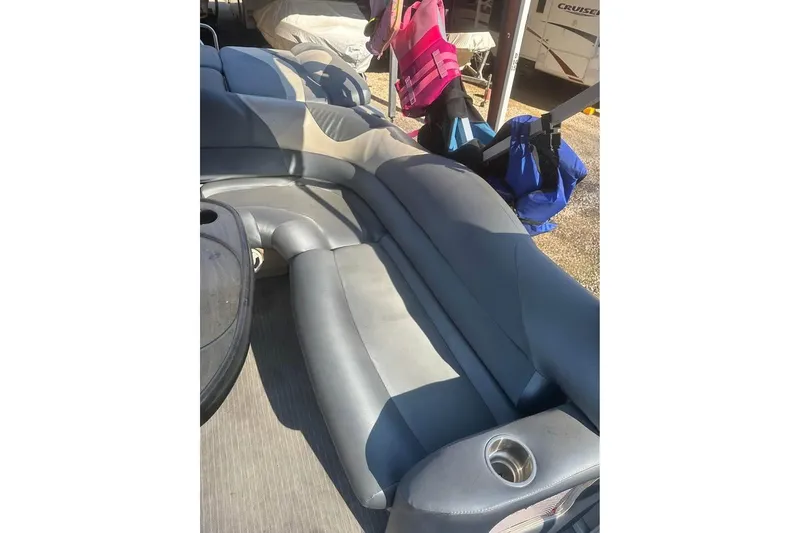 Slide: The Image of 2008 Crestliner Grand Cayman 2585 boat interior with gray seating and cup holders. - 5