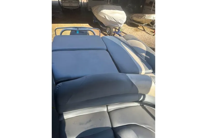 Slide: The Image of 2008 Crestliner Grand Cayman 2585 boat interior with blue cushioned seating. - 6