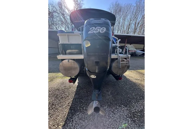 Slide: The Image of 2008 Crestliner Grand Cayman 2585 boat with powerful outboard motor in storage area. - 8