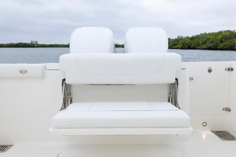 Slide: The Image of 2026 Pursuit DC 286 Dual Console boat with white seating, on calm water. - 14