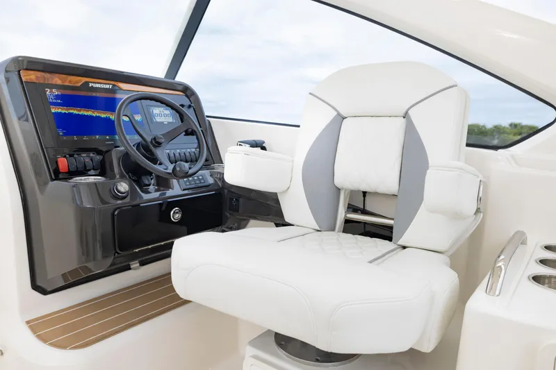 Slide: The Image of 2026 Pursuit DC 286 Dual Console helm with modern controls and luxurious seating. - 25