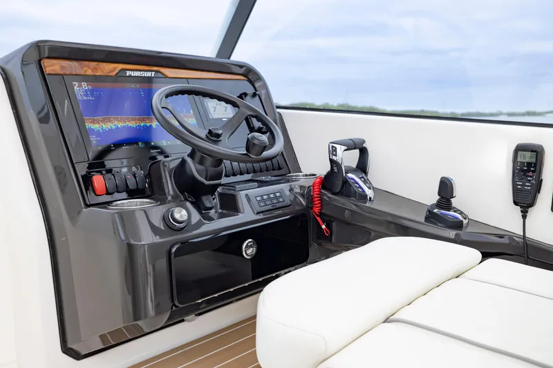 Slide: The Image of 2026 Pursuit DC 286 Dual Console helm with advanced controls and navigation display. - 26