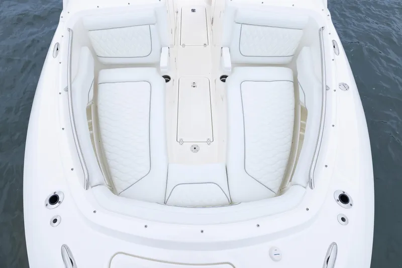 Slide: The Image of 2026 Pursuit DC 286 Dual Console boat interior with white cushioned seating. - 31