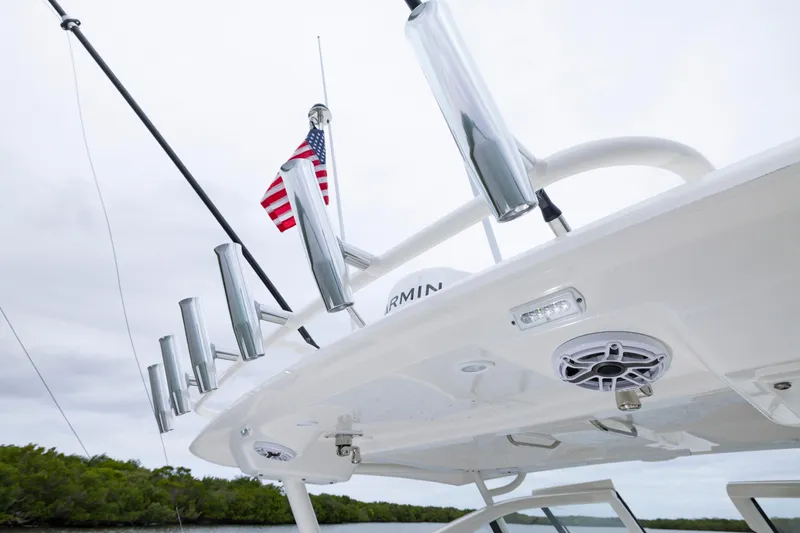 Slide: The Image of 2026 Pursuit DC 286 Dual Console boat with rod holders and American flag. - 36