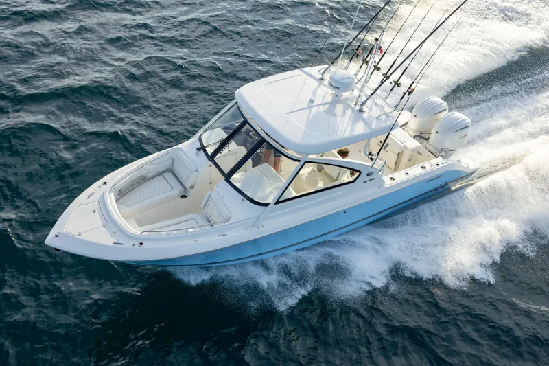 Slide: The Image of 2026 Pursuit DC 286 Dual Console boat cruising on open water. - 4