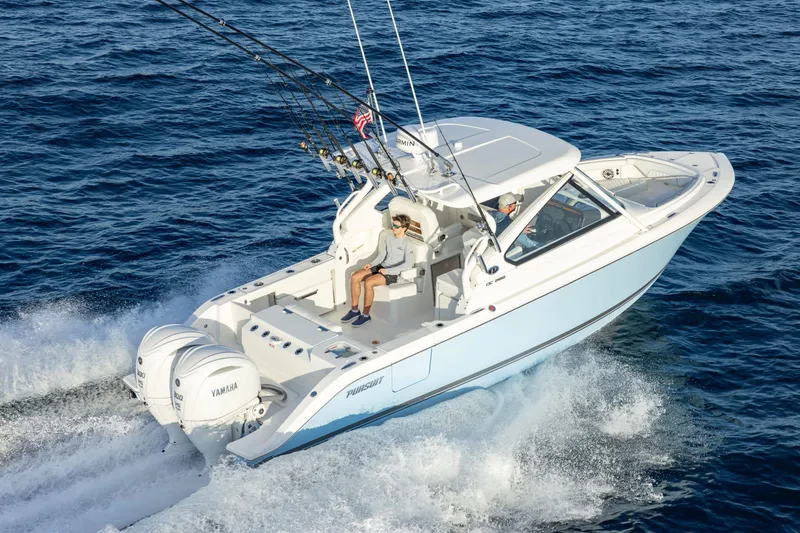 Slide: The Image of 2026 Pursuit DC 286 Dual Console boat cruising on open water. - 6
