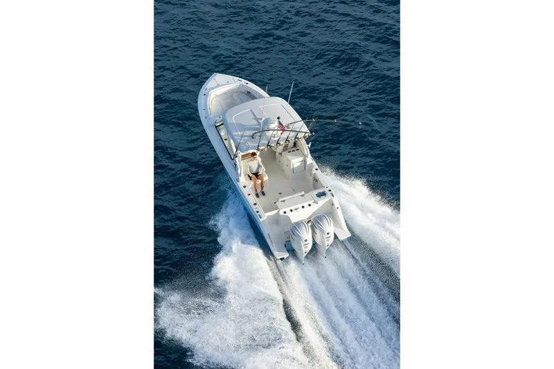 Slide: The Image of 2026 Pursuit DC 286 Dual Console boat cruising on open water, aerial view. - 9