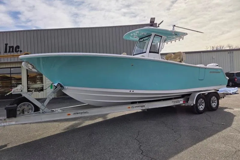 The Image of 2026 Sportsman Open 262 Center Console boat on trailer, parked outdoors. - 0