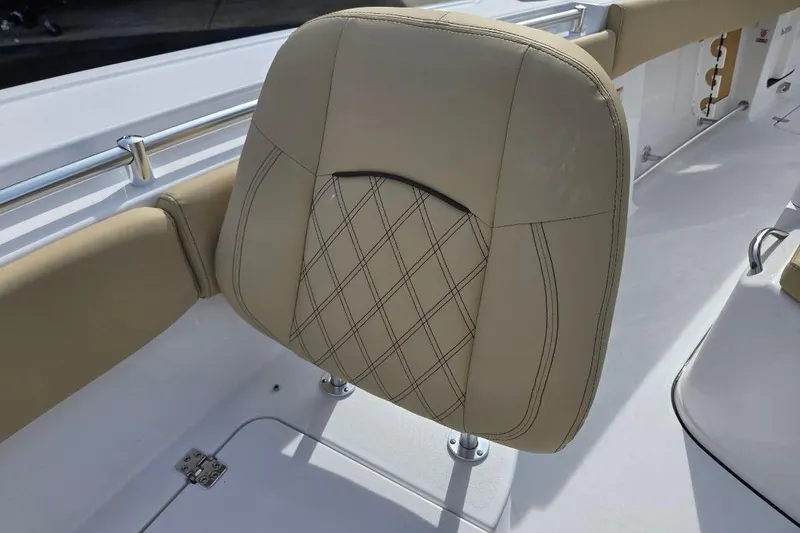 Slide: The Image of 2026 Sportsman Open 262 Center Console boat seat with beige upholstery and diamond stitching. - 11
