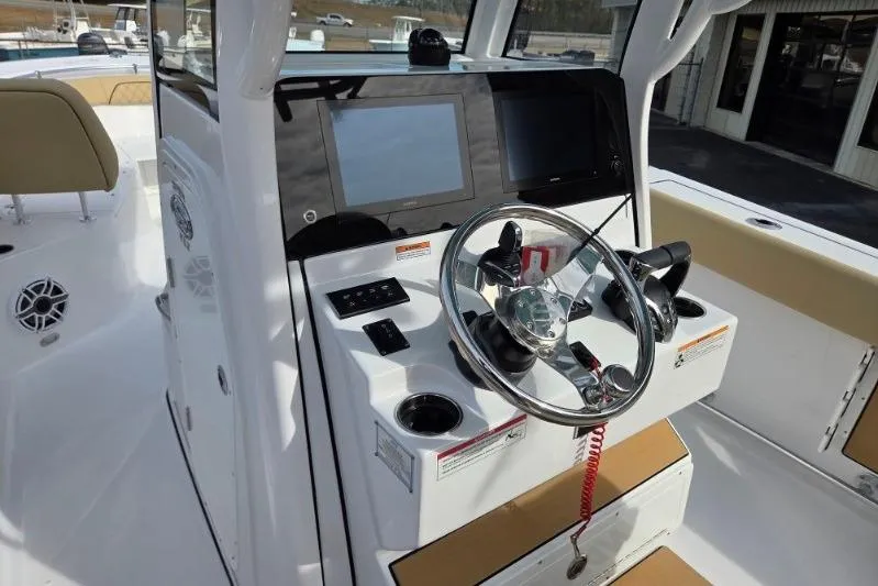Slide: The Image of 2026 Sportsman Open 262 Center Console boat dashboard with steering wheel and digital displays. - 13