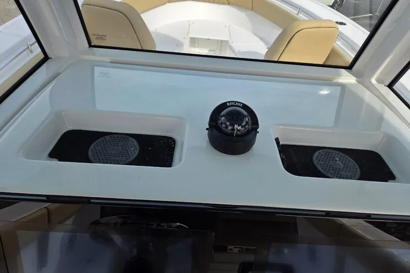 Slide: The Image of 2026 Sportsman Open 262 Center Console dashboard with compass and storage compartments. - 15