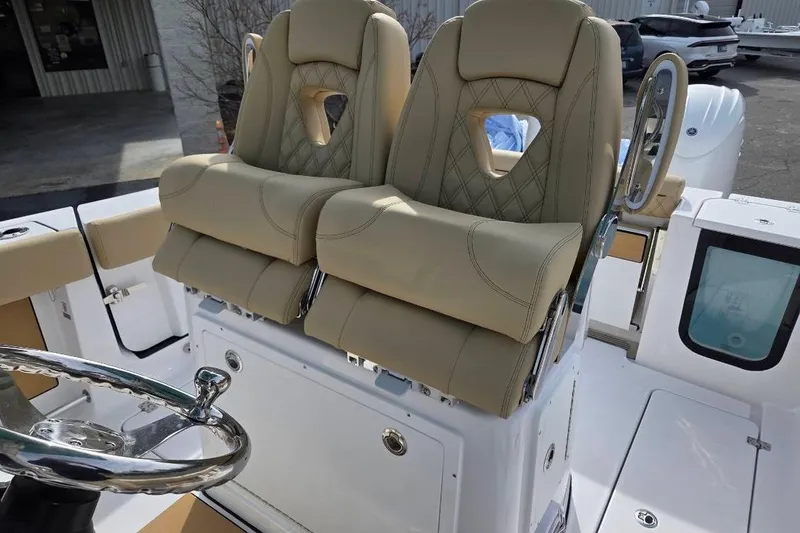 Slide: The Image of 2026 Sportsman Open 262 Center Console with luxurious beige seating and steering wheel. - 16