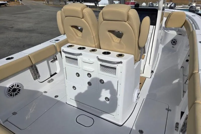 Slide: The Image of 2026 Sportsman Open 262 Center Console boat interior with beige seating and storage compartments. - 17