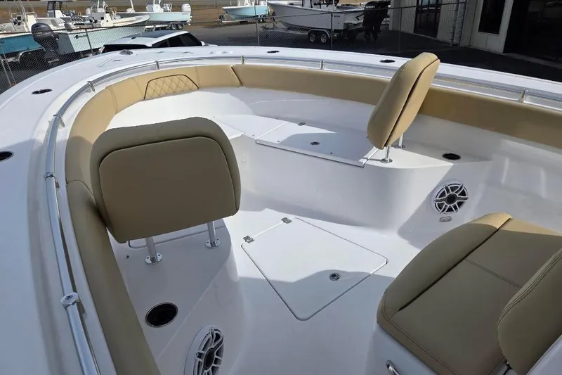 Slide: The Image of 2026 Sportsman Open 262 Center Console boat interior with beige seating and storage compartments. - 9