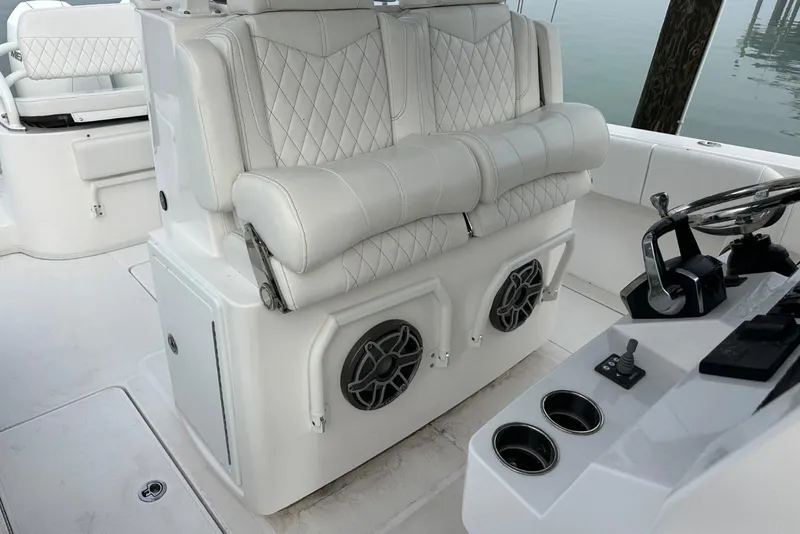 Slide: The Image of 2024 Fountain 38 Center Console boat interior with white seating and control panel. - 15