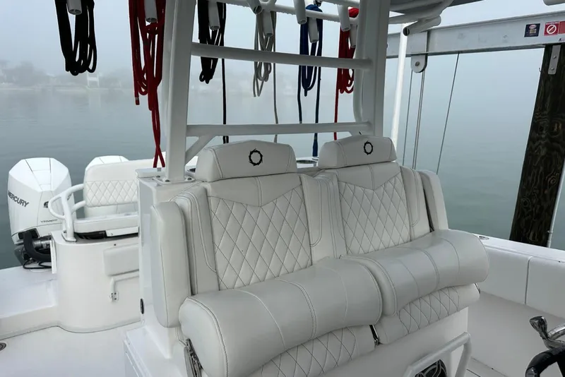Slide: The Image of 2024 Fountain 38 Center Console boat interior with luxurious seating and Mercury engines. - 16