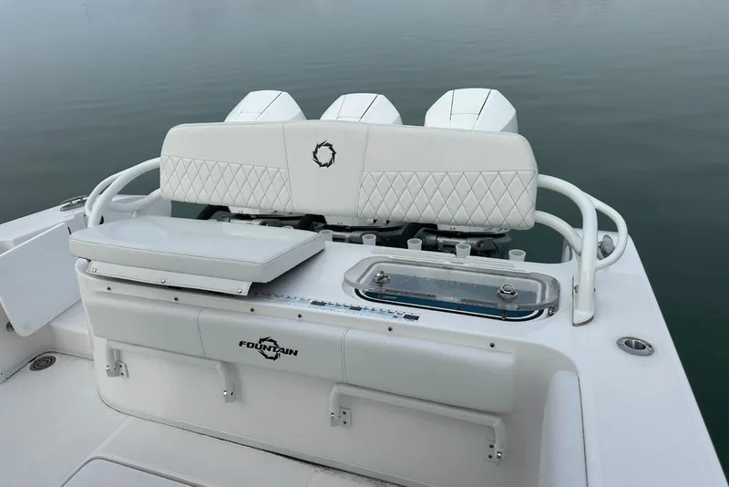 Slide: The Image of 2024 Fountain 38 Center Console boat with white seating and triple engines. - 18