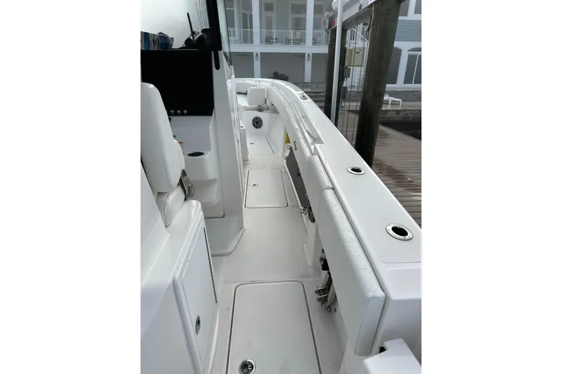 Slide: The Image of 2024 Fountain 38 Center Console boat interior with sleek white seating and modern design. - 21