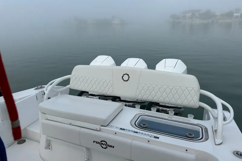 Slide: The Image of 2024 Fountain 38 Center Console boat with triple engines in foggy waters. - 24