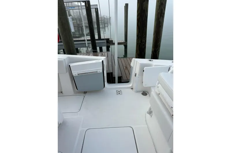 Slide: The Image of 2024 Fountain 38 Center Console boat deck with dock view in foggy marina. - 25