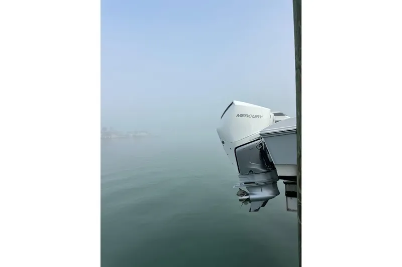 Slide: The Image of 2024 Fountain 38 Center Console with Mercury outboard engine on calm water. - 26