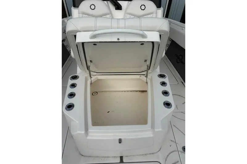 Slide: The Image of 2024 Fountain 38 Center Console boat with open storage compartment and cup holders. - 3