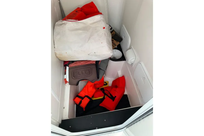 Slide: The Image of Storage compartment in 2024 Fountain 38 Center Console with life jackets and safety gear. - 4