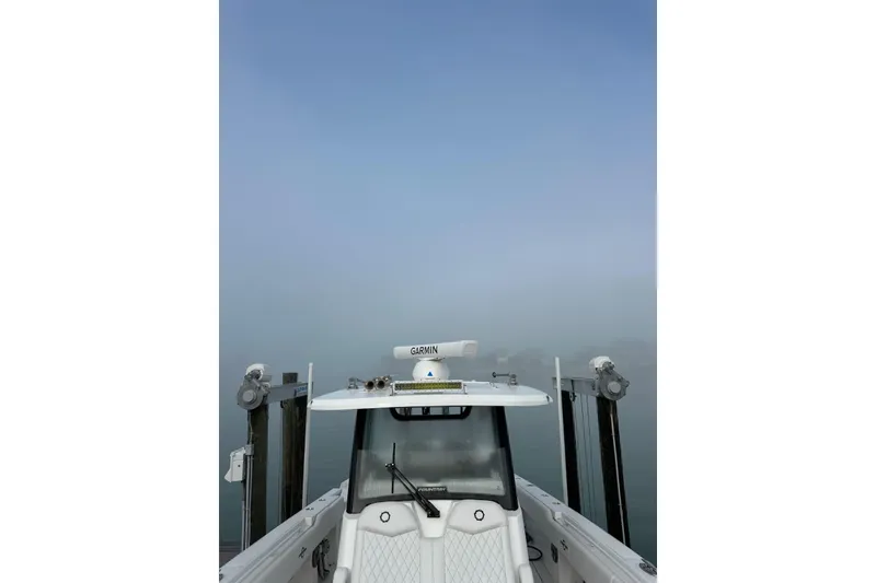 Slide: The Image of 2024 Fountain 38 Center Console boat docked in foggy marina. - 5