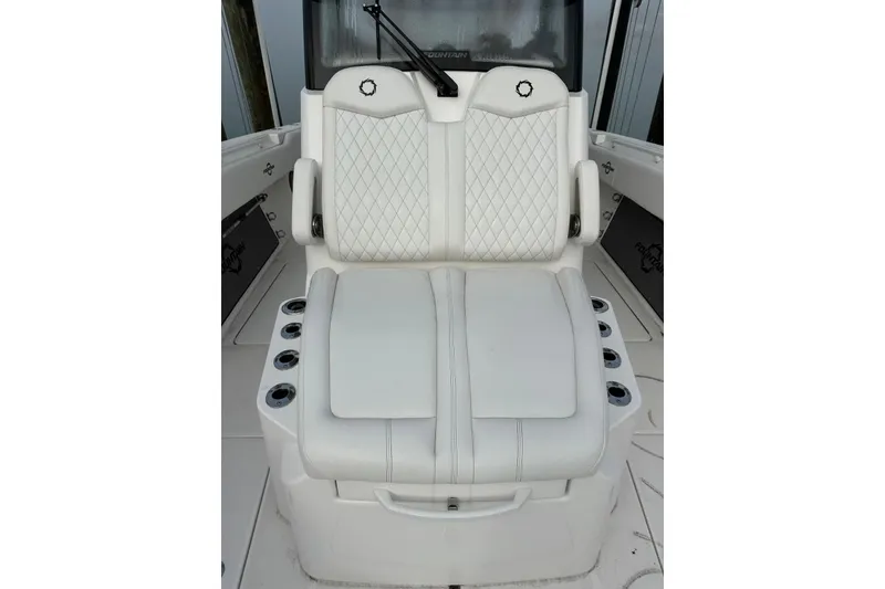 Slide: The Image of 2024 Fountain 38 Center Console boat seat with diamond-stitched upholstery and cup holders. - 6