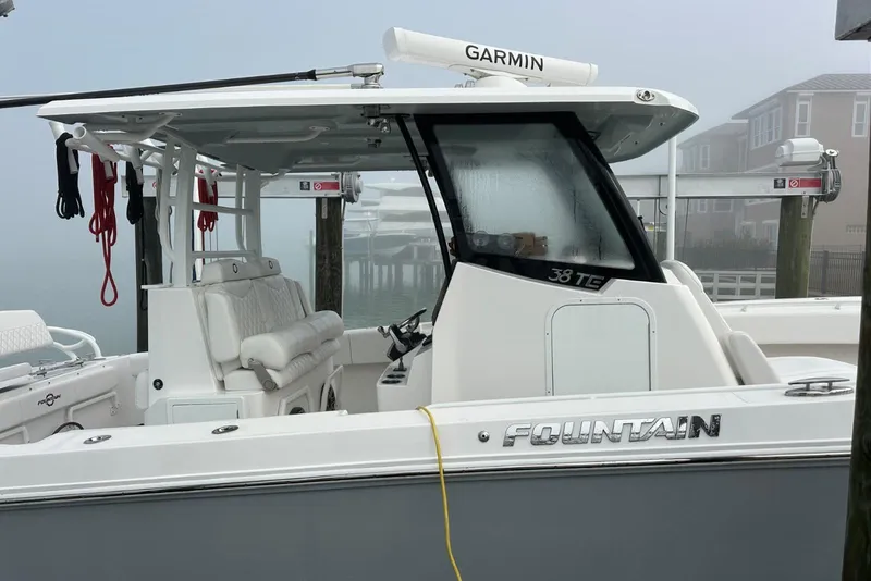 Slide: The Image of 2024 Fountain 38 Center Console boat docked, featuring Garmin equipment and sleek design. - 8