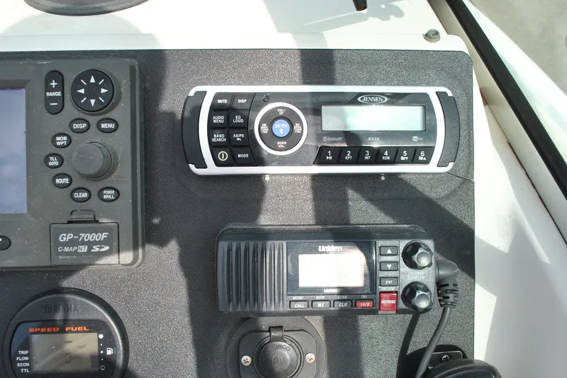 Slide: The Image of 1996 Pursuit 2150 Walkaround dashboard with marine electronics and radio controls. - 11