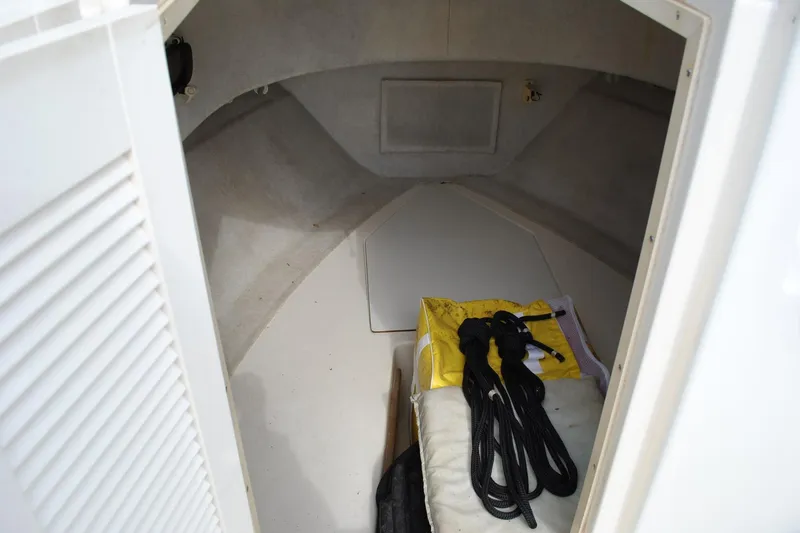 Slide: The Image of Interior cabin of 1996 Pursuit 2150 Walkaround boat with storage and ropes. - 12