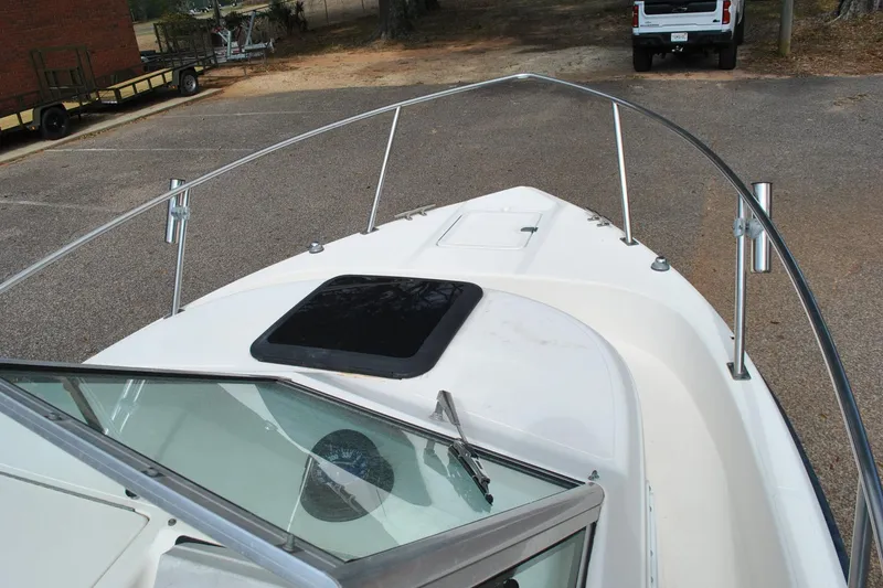 Slide: The Image of 1996 Pursuit 2150 Walkaround boat bow view with windshield and railing. - 17