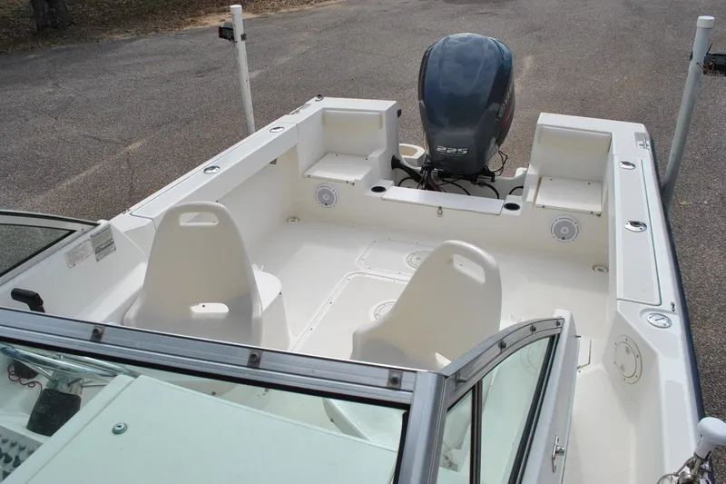 Slide: The Image of 1996 Pursuit 2150 Walkaround boat interior with seating and outboard motor. - 19