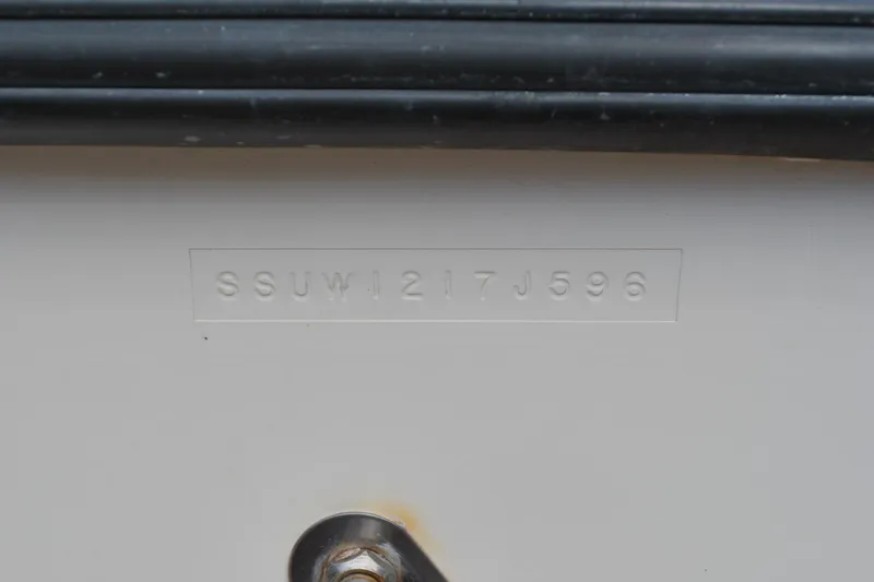 Slide: The Image of 1996 Pursuit 2150 Walkaround boat hull identification number (HIN) on white surface. - 22