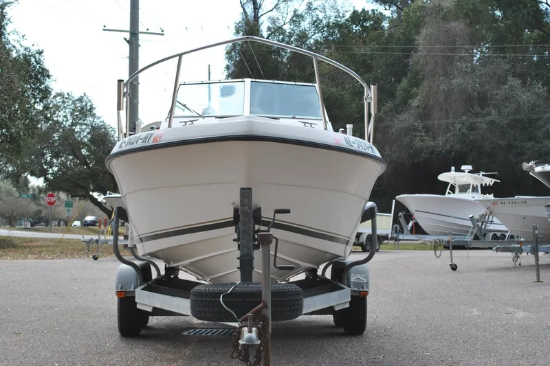 Slide: The Image of 1996 Pursuit 2150 Walkaround boat on trailer, parked outdoors. - 3
