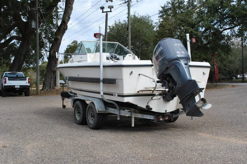 Slide: The Image of 1996 Pursuit 2150 Walkaround boat on trailer with Yamaha outboard motor in parking lot. - 8