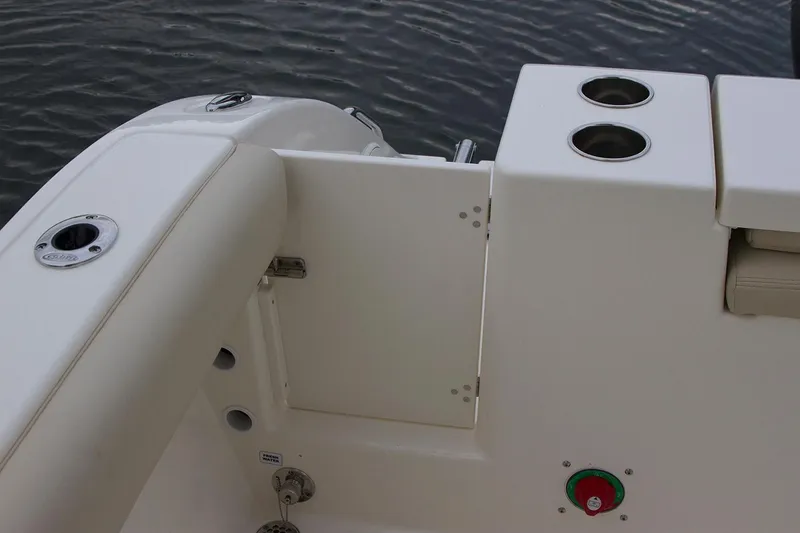 Slide: The Image of Manufacturer Provided Image: 2019 Cobia 220 Center Console boat interior, featuring rod holders and access hatch. - 11