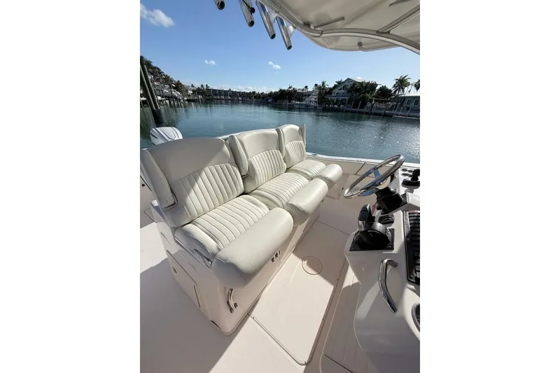 Slide: The Image of 2011 Grady-White Canyon 336 boat interior with plush seating and steering console. - 11