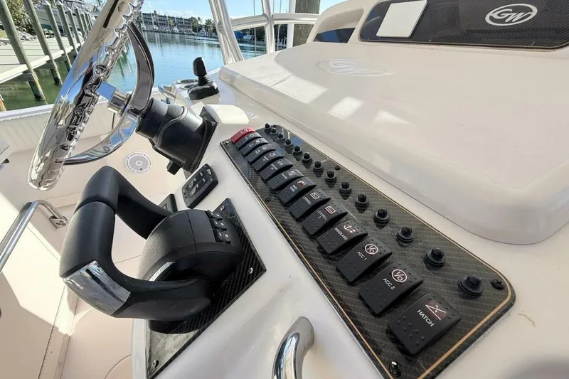 Slide: The Image of 2011 Grady-White Canyon 336 helm with steering wheel and control panel. - 16
