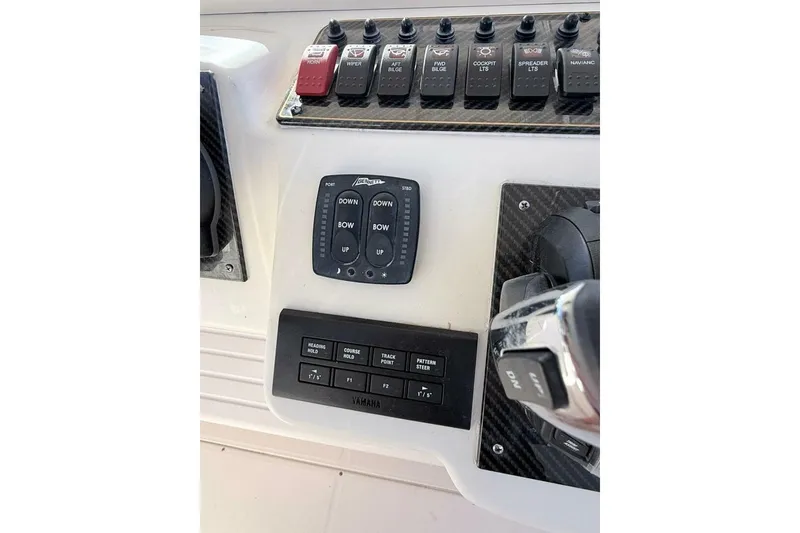 Slide: The Image of Control panel of a 2011 Grady-White Canyon 336 boat with switches and buttons. - 17