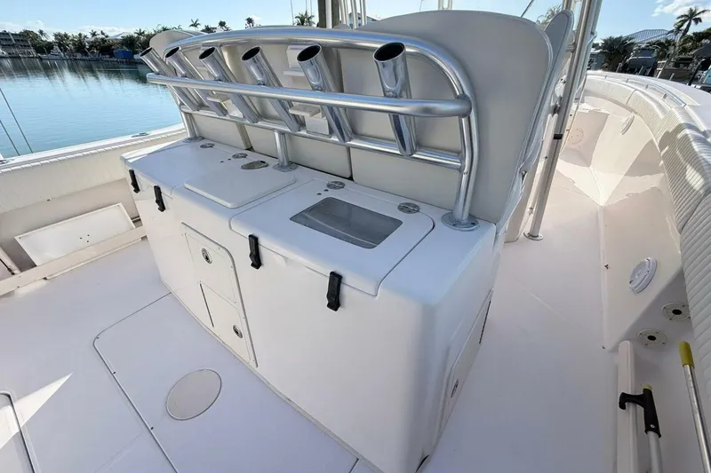 Slide: The Image of 2011 Grady-White Canyon 336 boat interior with rod holders and storage compartments. - 2