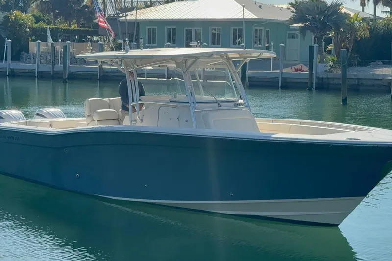 Slide: The Image of 2011 Grady-White Canyon 336 boat docked in a serene marina setting. - 28