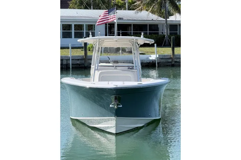 Slide: The Image of 2011 Grady-White Canyon 336 boat docked, front view with American flag. - 29