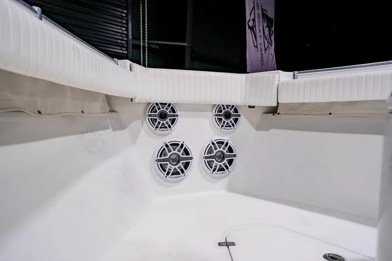 Slide: The Image of 2012 Yellowfin 39 Offshore boat interior with white seating and audio speakers. - 10