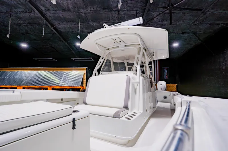 Slide: The Image of 2012 Yellowfin 39 Offshore boat interior with sleek white seating and modern design. - 15