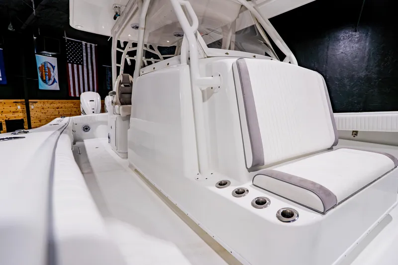 Slide: The Image of 2012 Yellowfin 39 Offshore boat interior with white seating and rod holders. - 18
