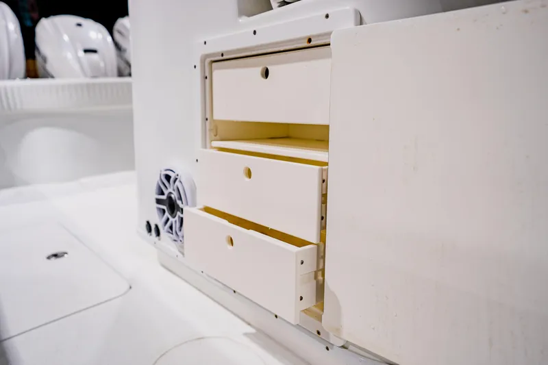 Slide: The Image of 2012 Yellowfin 39 Offshore boat interior with storage drawers and speaker. - 21