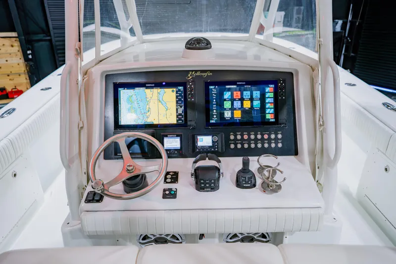 Slide: The Image of 2012 Yellowfin 39 Offshore boat dashboard with navigation screens and controls. - 23