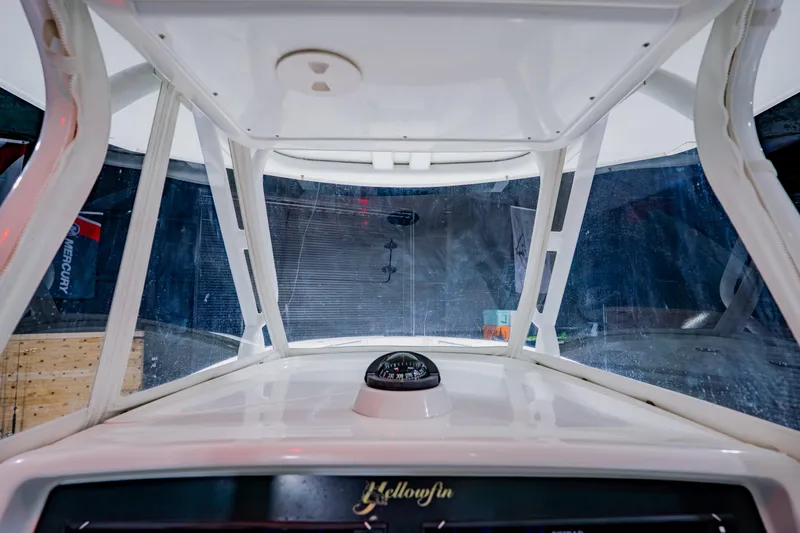 Slide: The Image of 2012 Yellowfin 39 Offshore boat interior with compass and windshield view. - 25